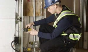 person installing service garage door safety