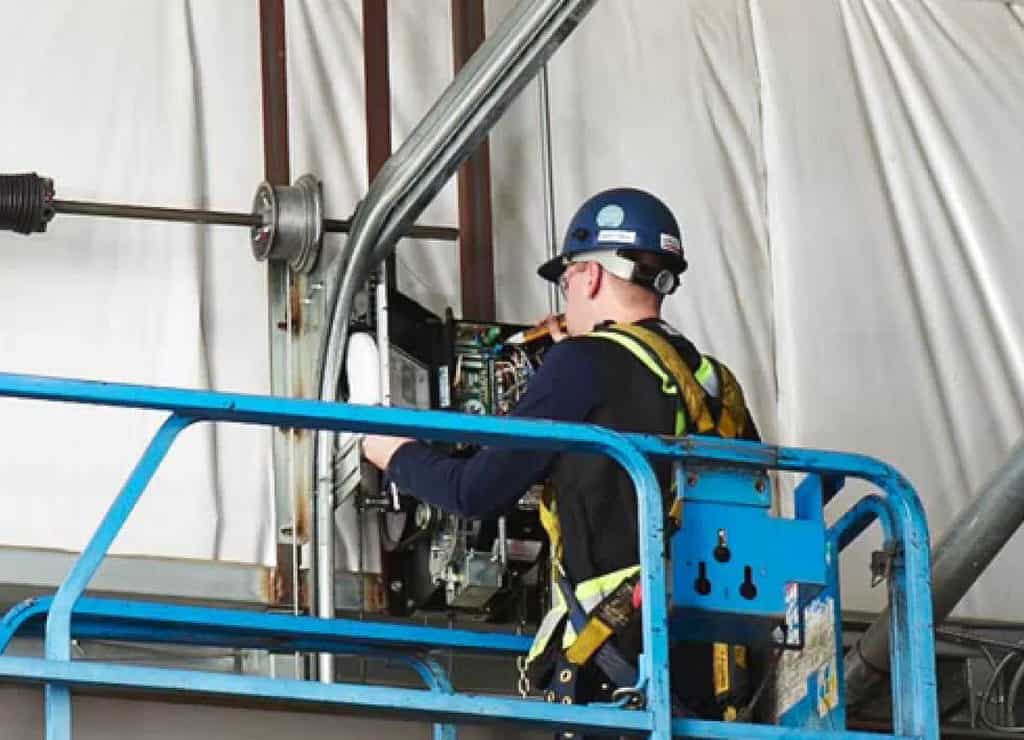 person installing commercial garage door